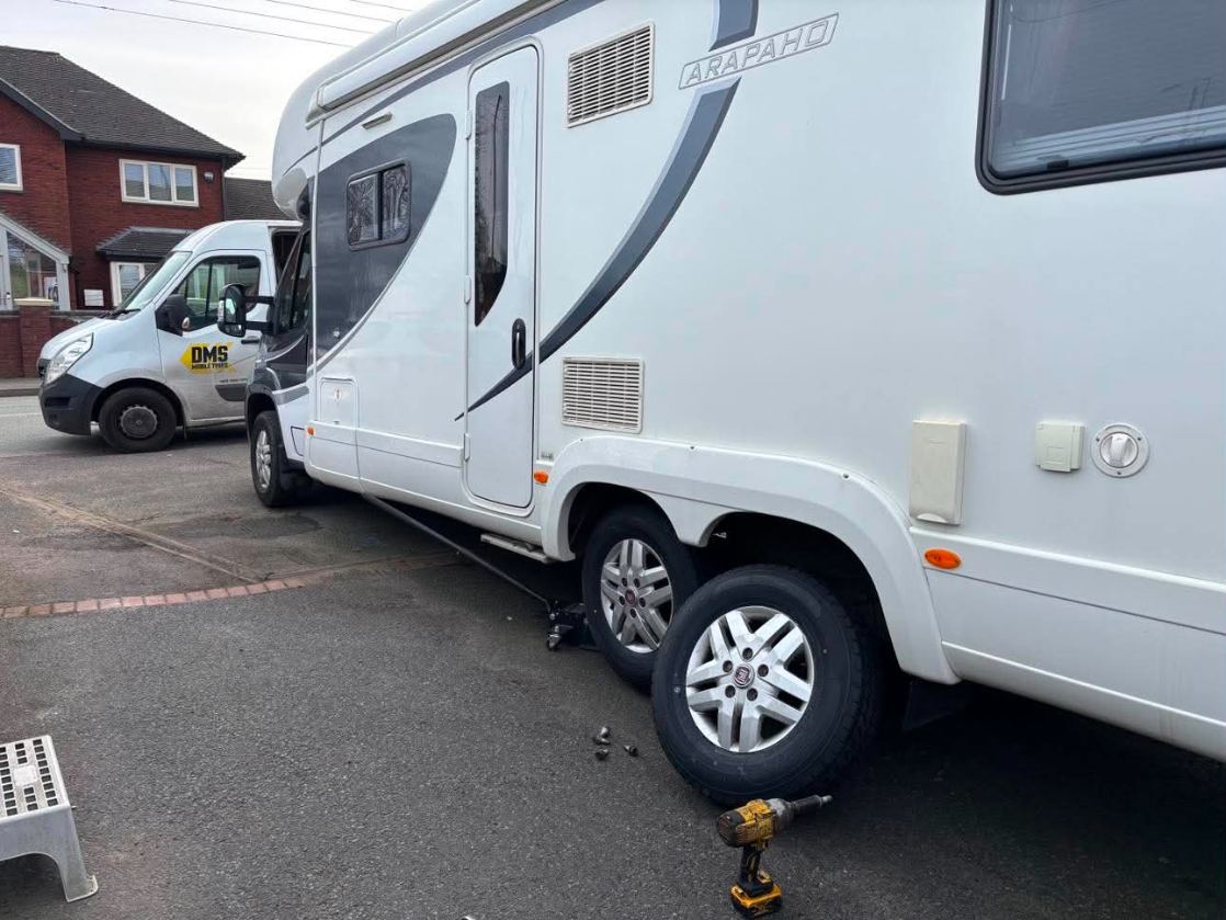 Elddis Arapaho motorhome beside the DMS Mobile Tyres van during a wheel change