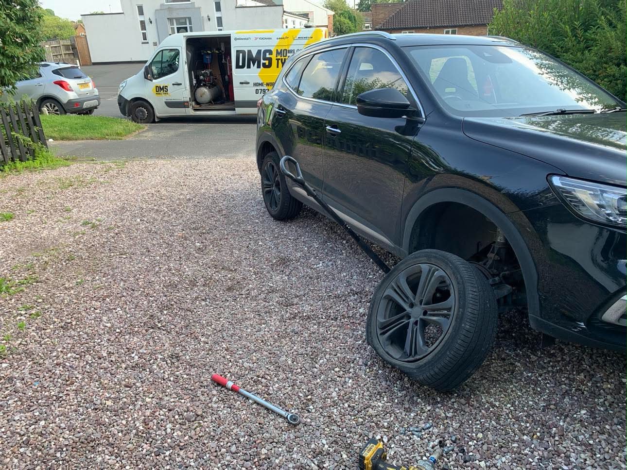 DMS Tyres mobile tyre fitter fitting a tyre in Cheadle