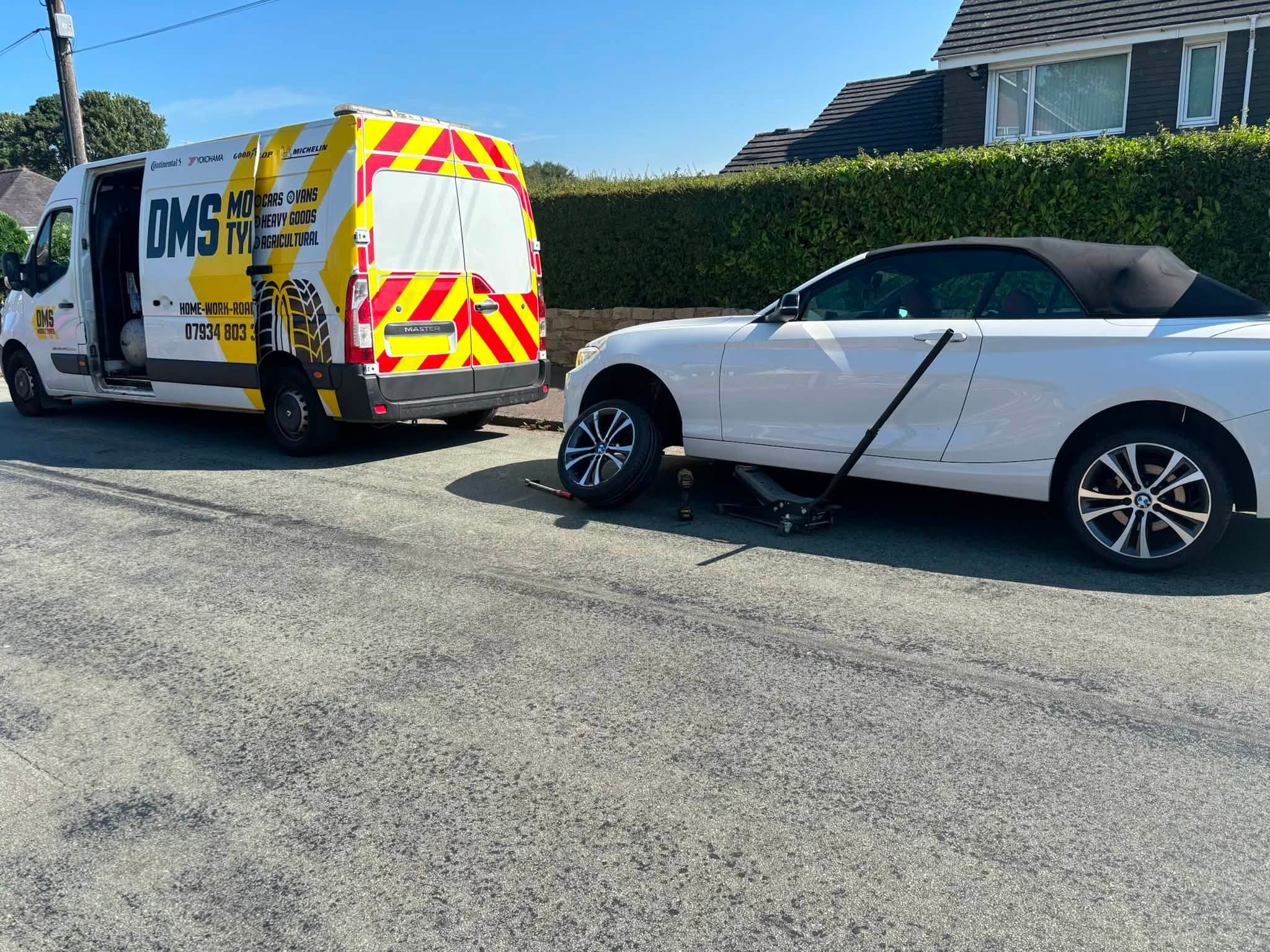 DMS Tyres mobile van fitting a tyre to a car at a customer address