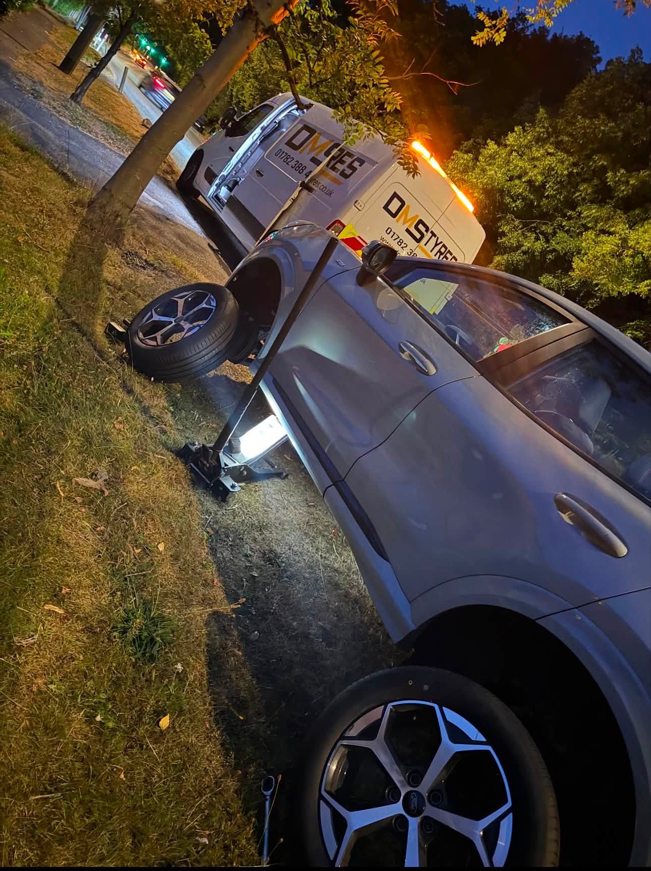 DMS Tyres van attending a night-time roadside tyre change