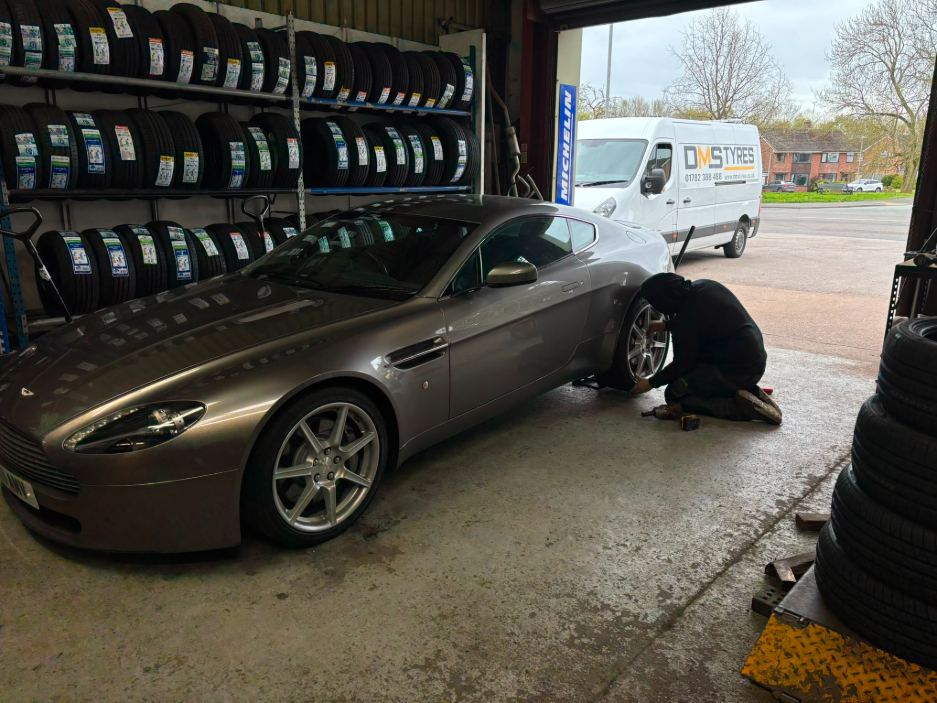 DMS technician fitting tyres in the garage
